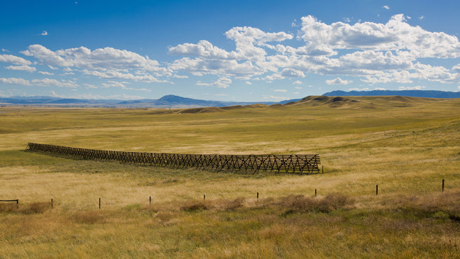 The Big Hollow in Wyoming is the world's second largest hollow and is completely wind-formed seen with a section of snow fence.