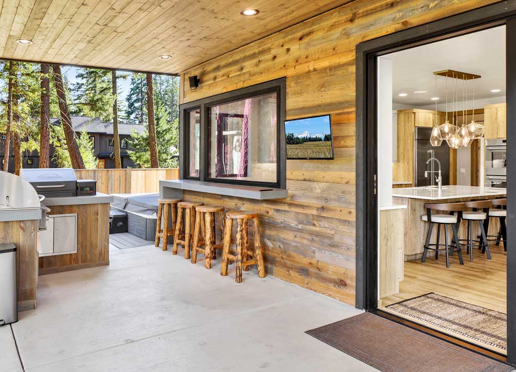 Reclaimed wood siding on a grilling area of a modern rustice house in the Cheyenne finish on an exterior by Eide Homes in Cle Elum, WA