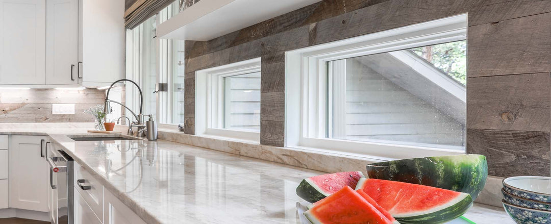 Gray reclaimed wood planks from Centennial Woods used in a modern kitchen as an accent wall and backsplash - designed by Alexa Interiors in Evergreen, Colorado.