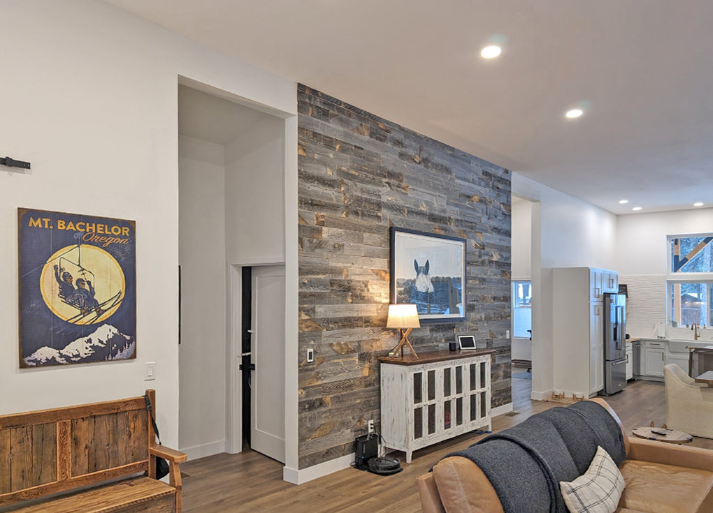 Gray reclaimed wood accent wall in an open floor plan room.