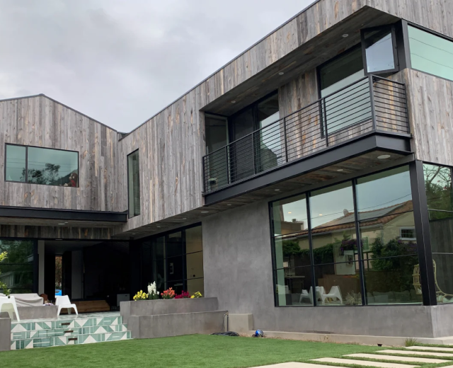 Vertical reclaimed wood siding in grey.