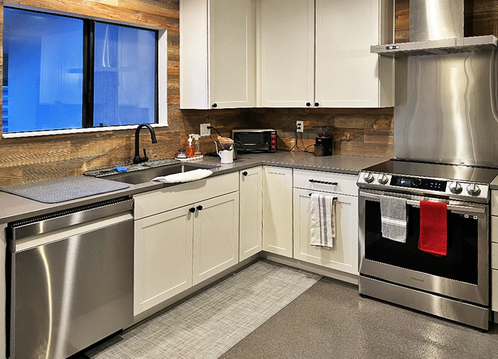 Dark brown reclaimed wood walls and backsplash in a modern kitchen