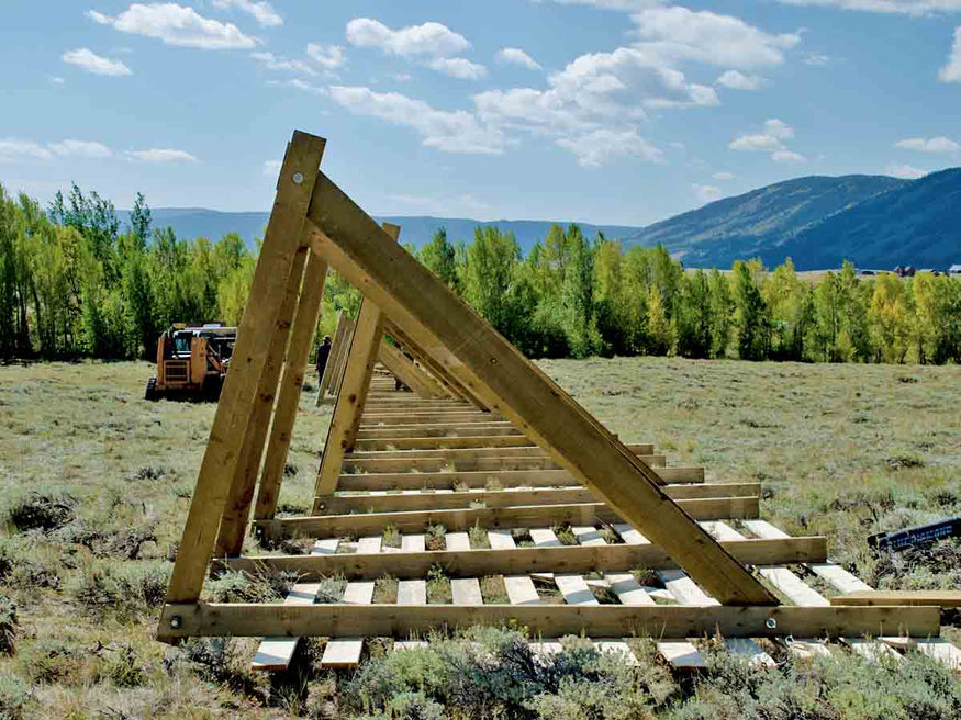 A snow fence under construction in the town of Centennial in Southeast Wyoming