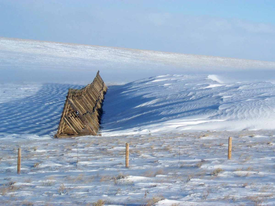 A snow fence during winter can create snow drifts as tall as 15 feet or more.