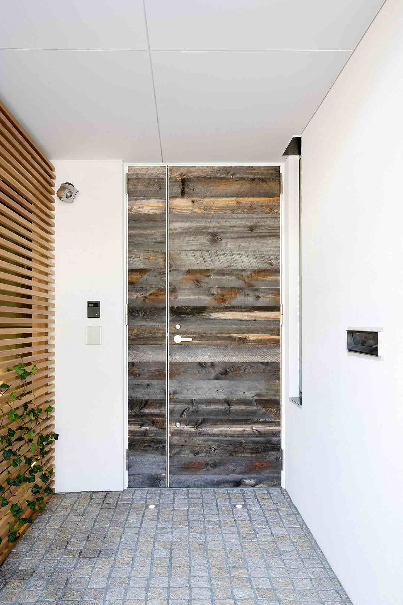 Custom reclaimed wood door in a modern house.