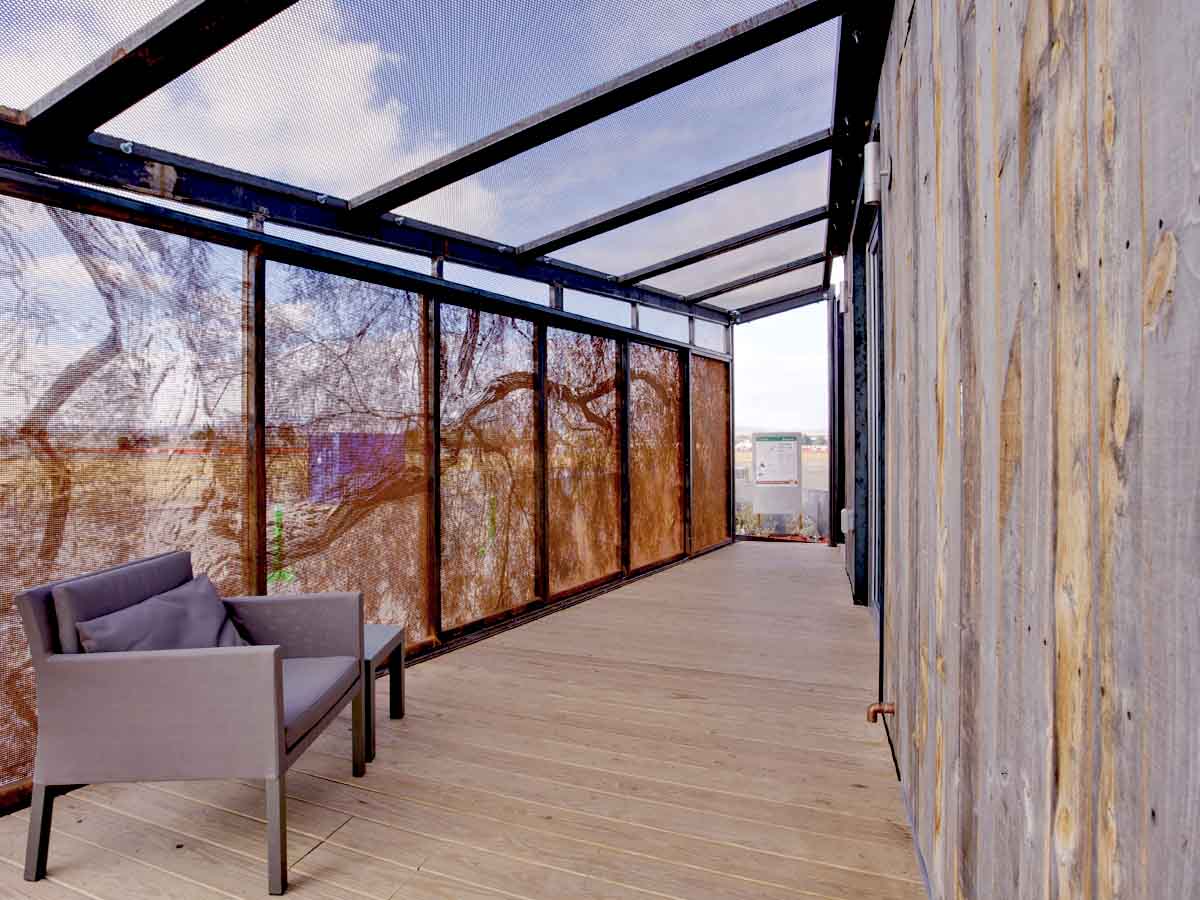 Modern home exterior featuring a vertical reclaimed wood facade from Centennial Woods.