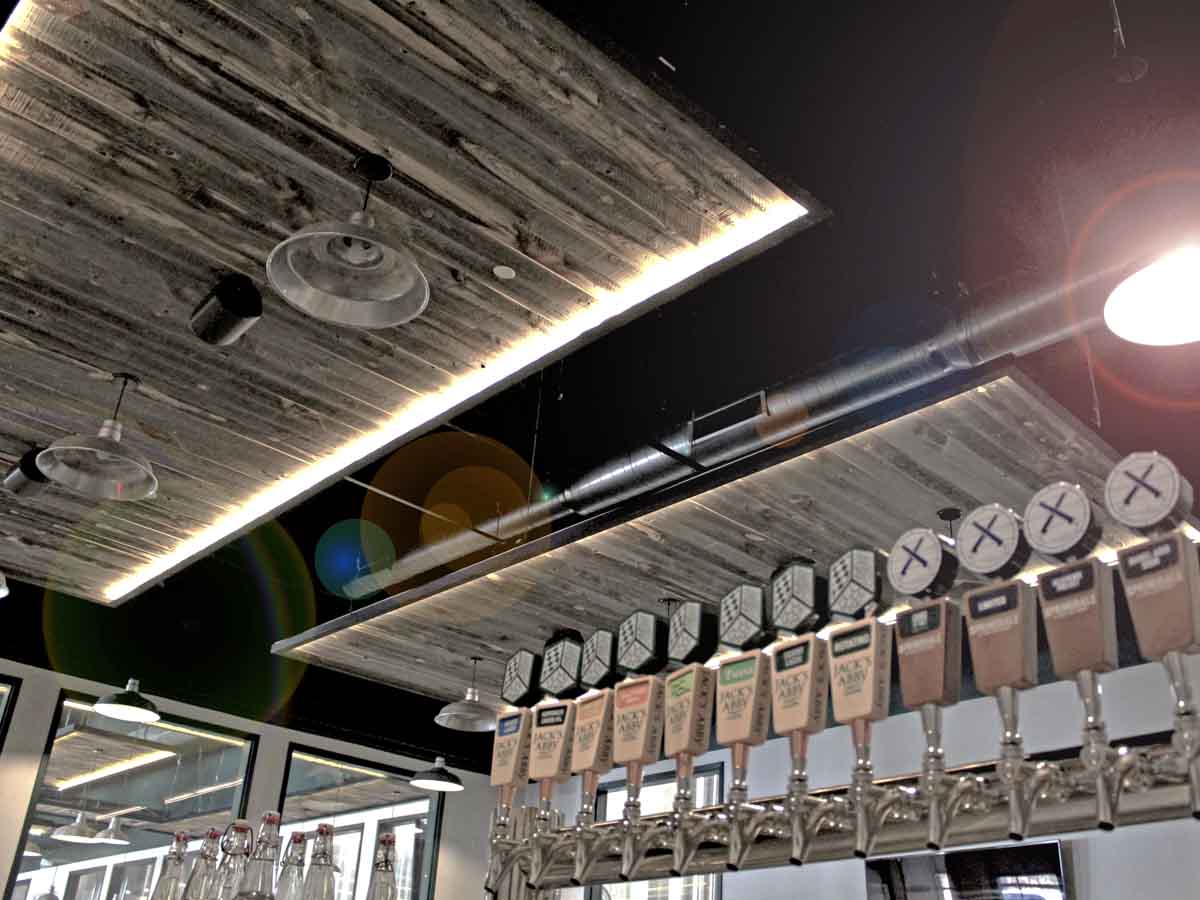 Reclaimed wood ceiling planks in a restaurant bar at Jack's Abbey in Massachussets.