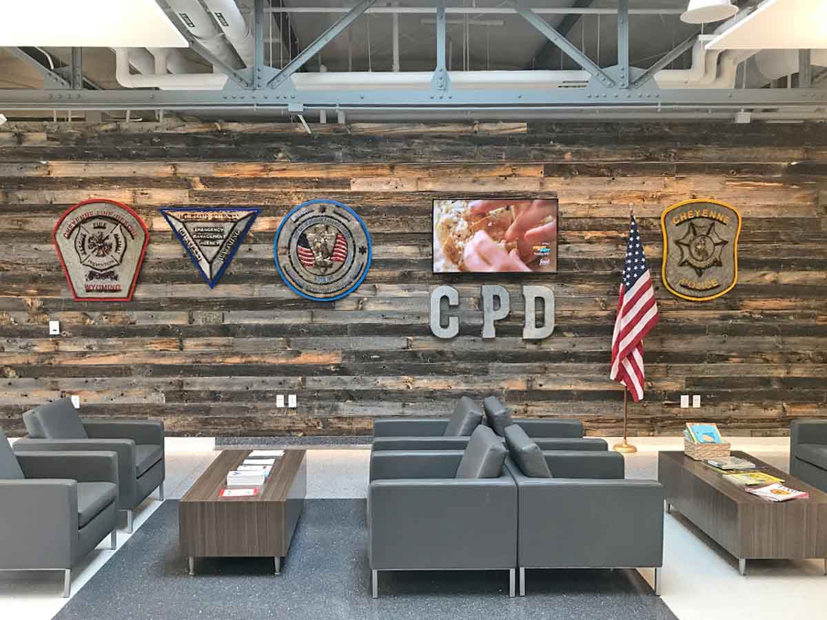Reclaimed wood wall planks installed in a municipal building lobby.
