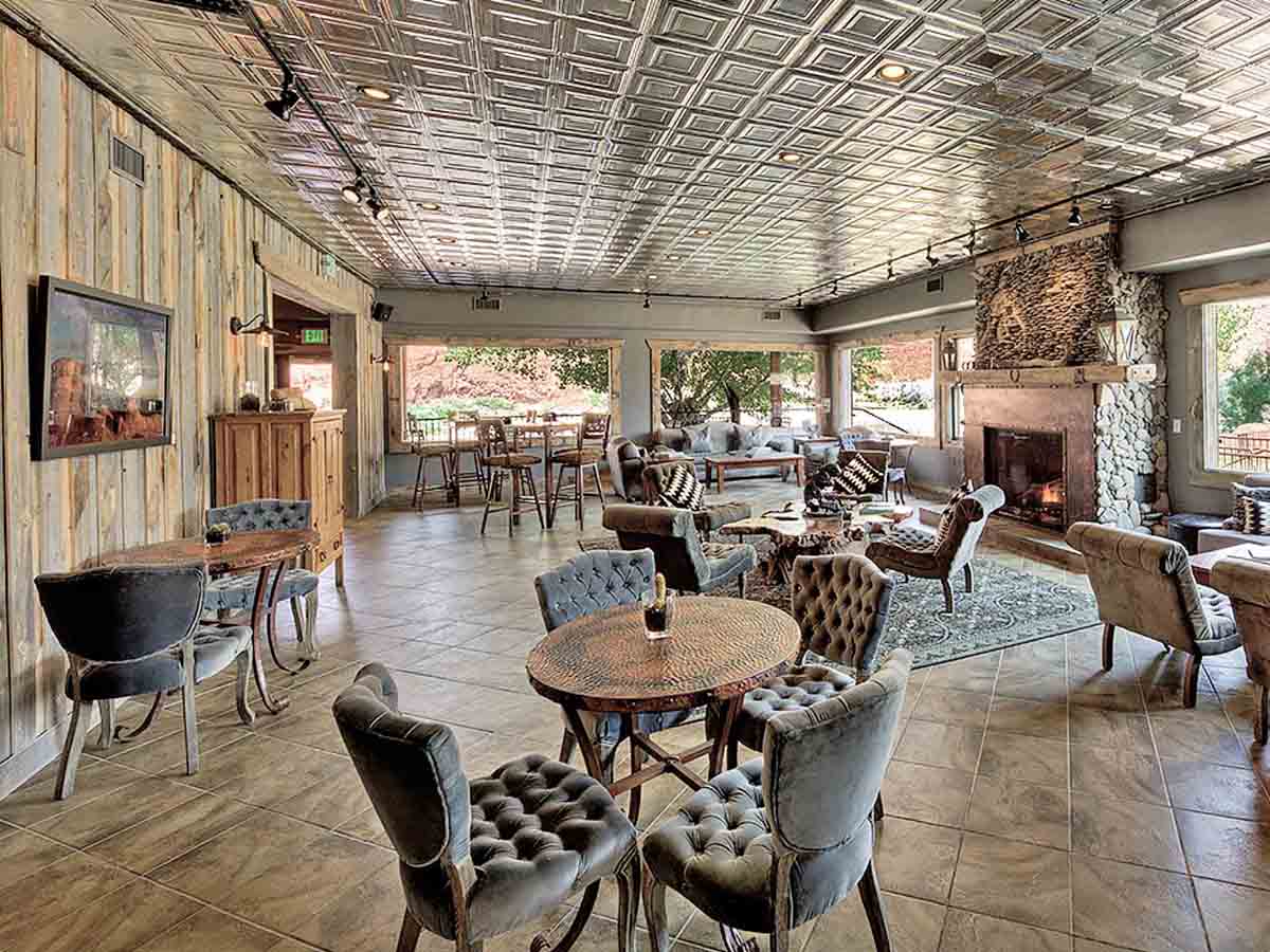 Grey reclaimed wood paneling installed vertically at a restaurant in the Sorrel River Hotel in Moab, UT.