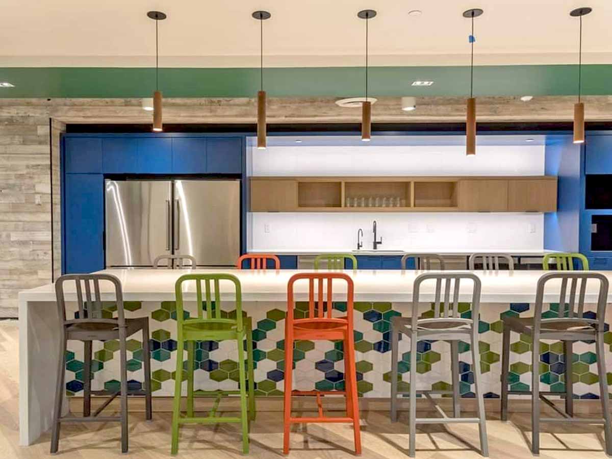 Reclaimed wood wall painted white in a colorful employee break room.