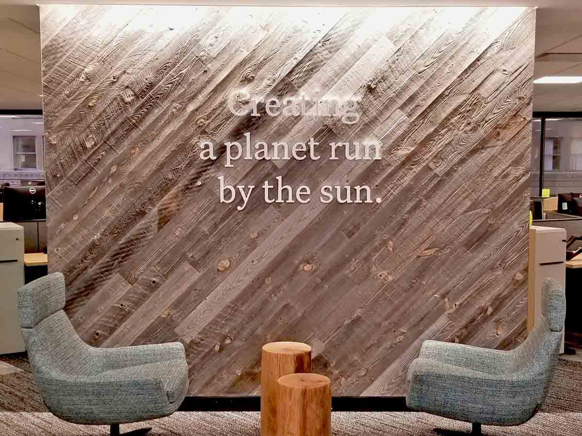 light, diagonal reclaimed wood accent wall at Sunrun Solar installed by Unique Woodworking.