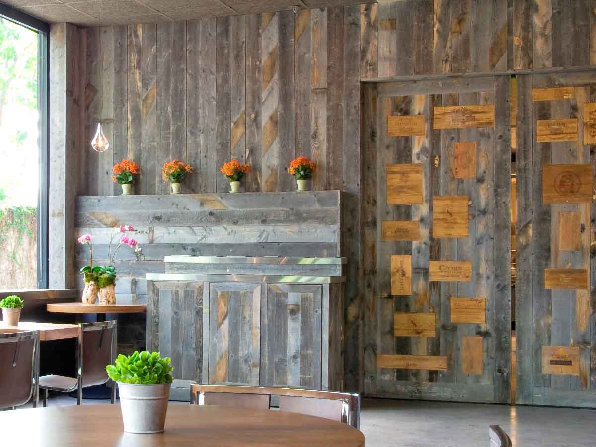 Custom grey reclaimed wood design walls at Tiato restaurant in California.