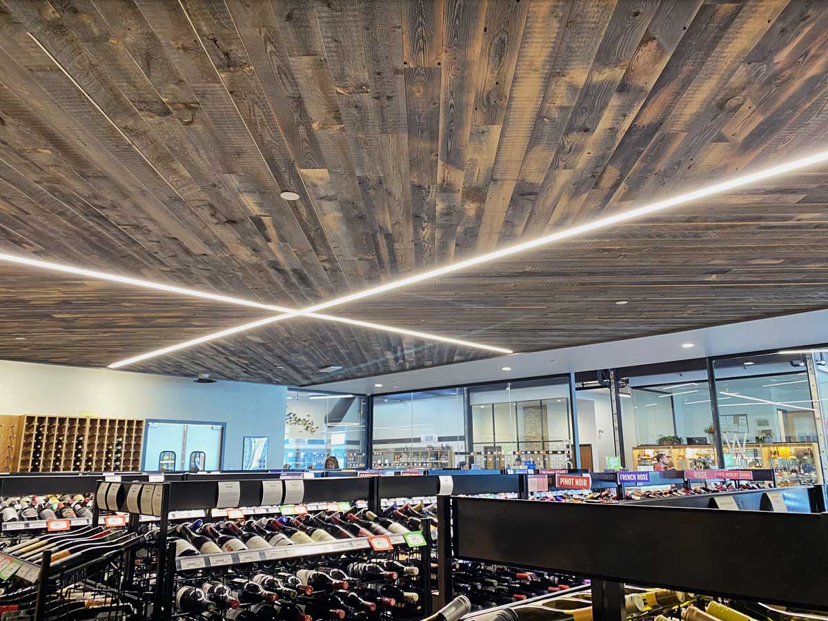 Diagonal reclaimed wood ceiling in a modern Utah state liquor store.