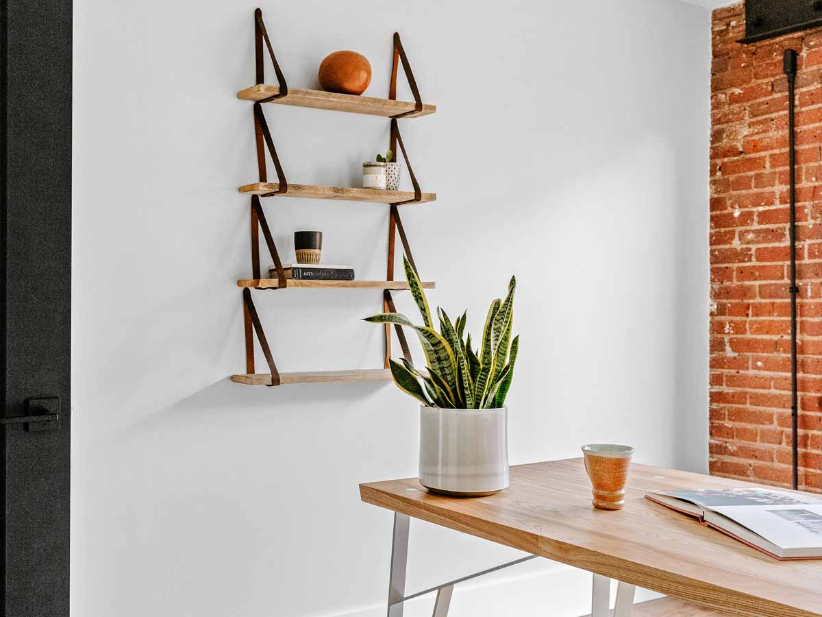 Brown reclaimed wood wall decor leather strap shelves by Centennial Woods and Range Leather