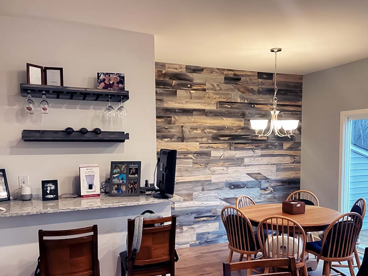 A light and dark reclaimed wood accent wall installed in a kitchen using Cody planks from Centennial Woods.