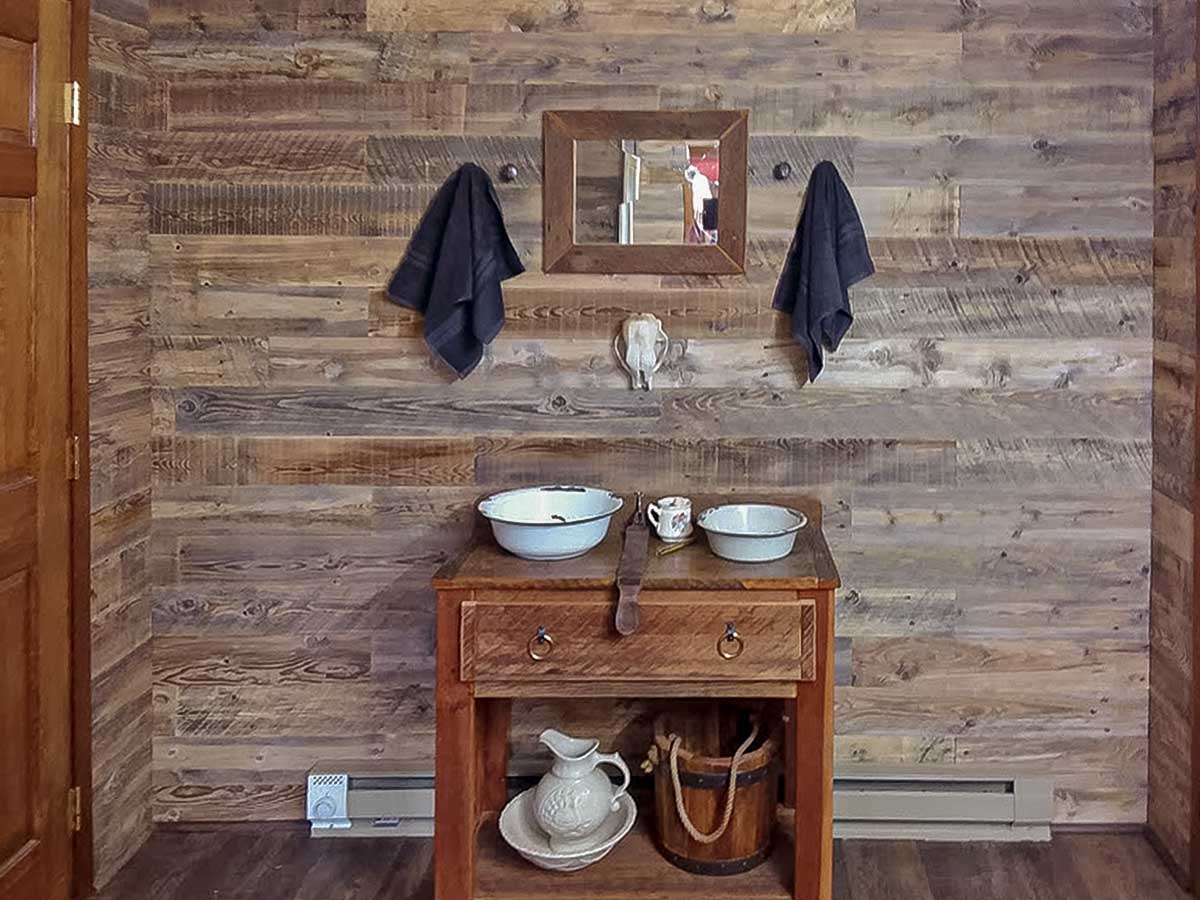 Reclaimed wood walls in a bathroom inside a rustic home in Idaho.