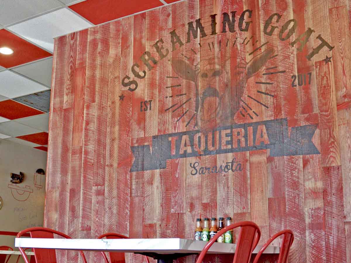 Distressed reclaimed wood wall at Screaming Goat Taqueria
