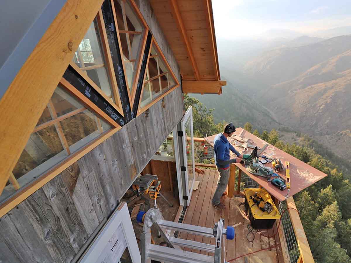 Grey, vertical reclaimed wood siding on a mountain house in the Boulder foothills in Colorado built by Treecraft Design.