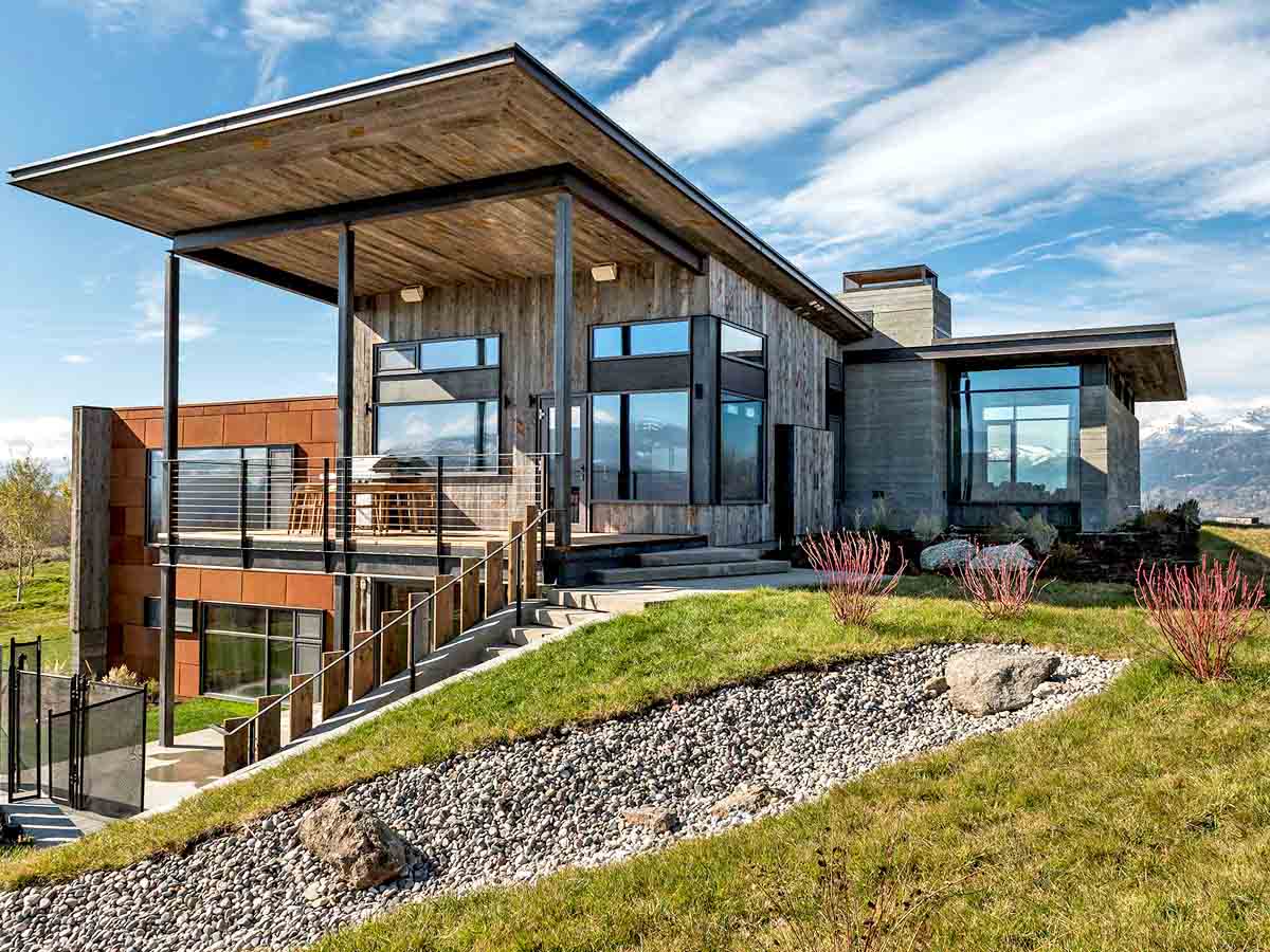 Grey, vertical reclaimed wood siding and soffits on a modern home in Teton mountain range in Wyoming.