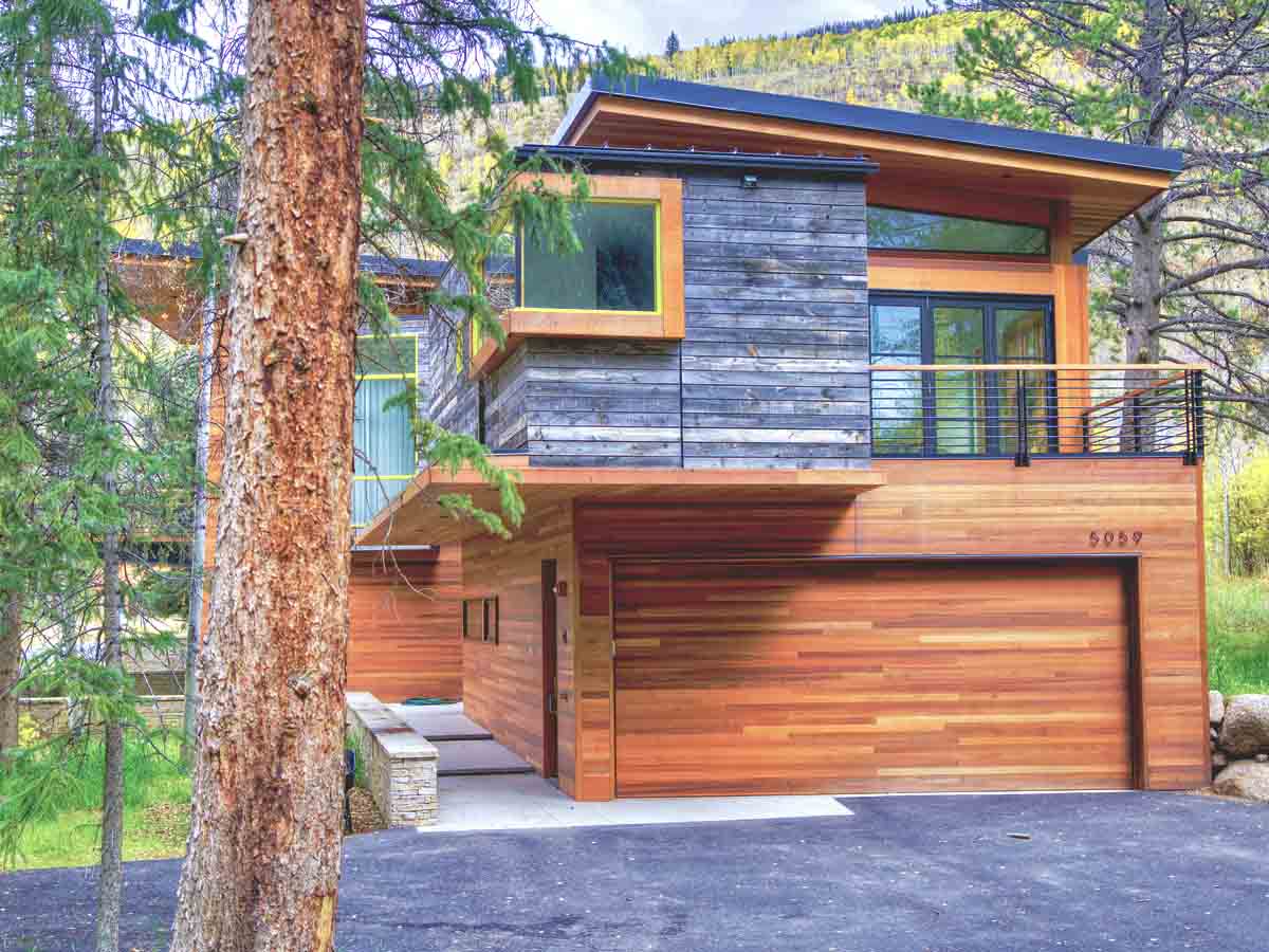 Modern rustic architecture featuring grey reclaimed wood siding by Centennial Woods near Vail, CO.