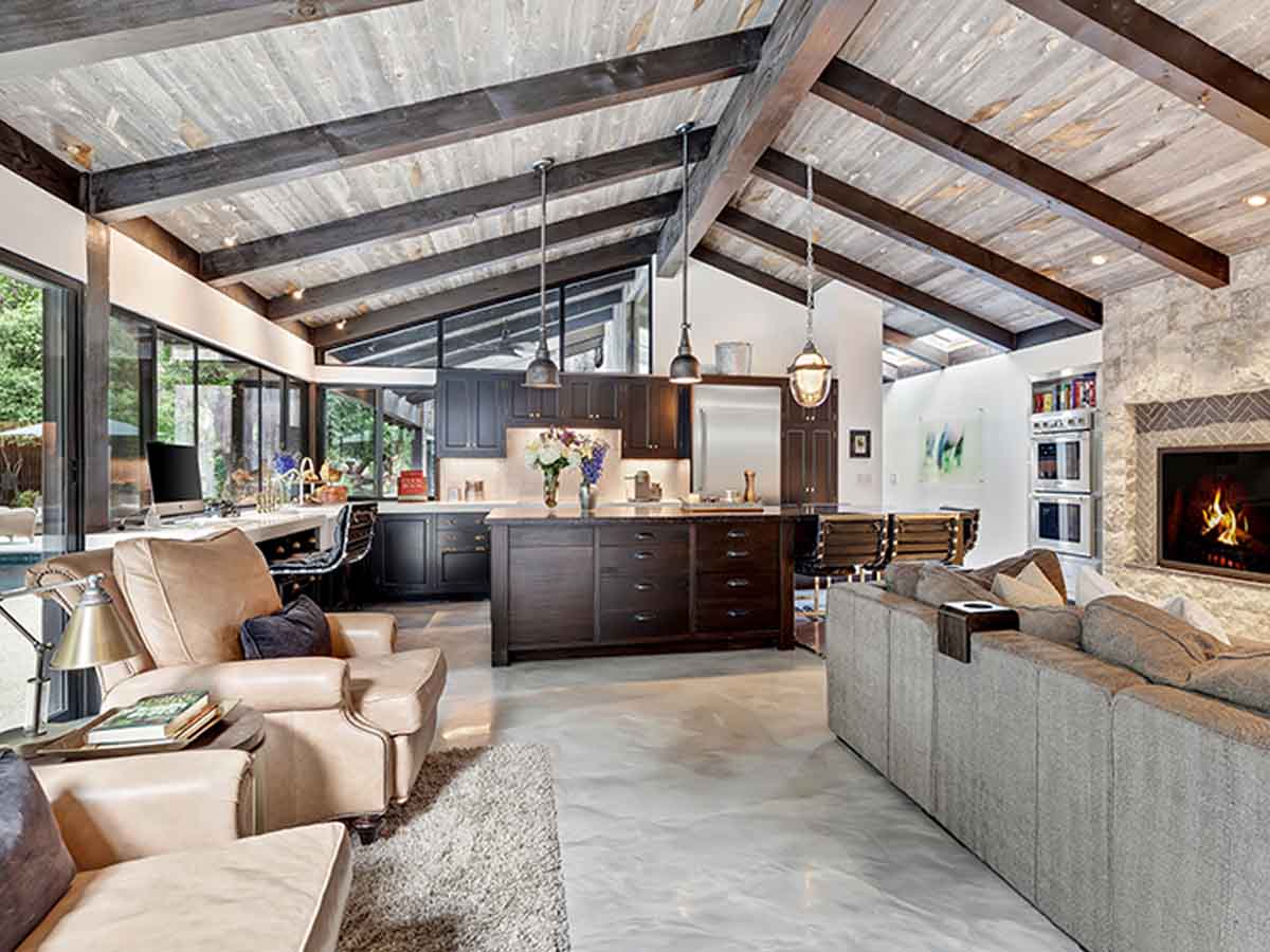 Grey, vaulted reclaimed wood ceiling and beams in an open floor plan in a modern house.
