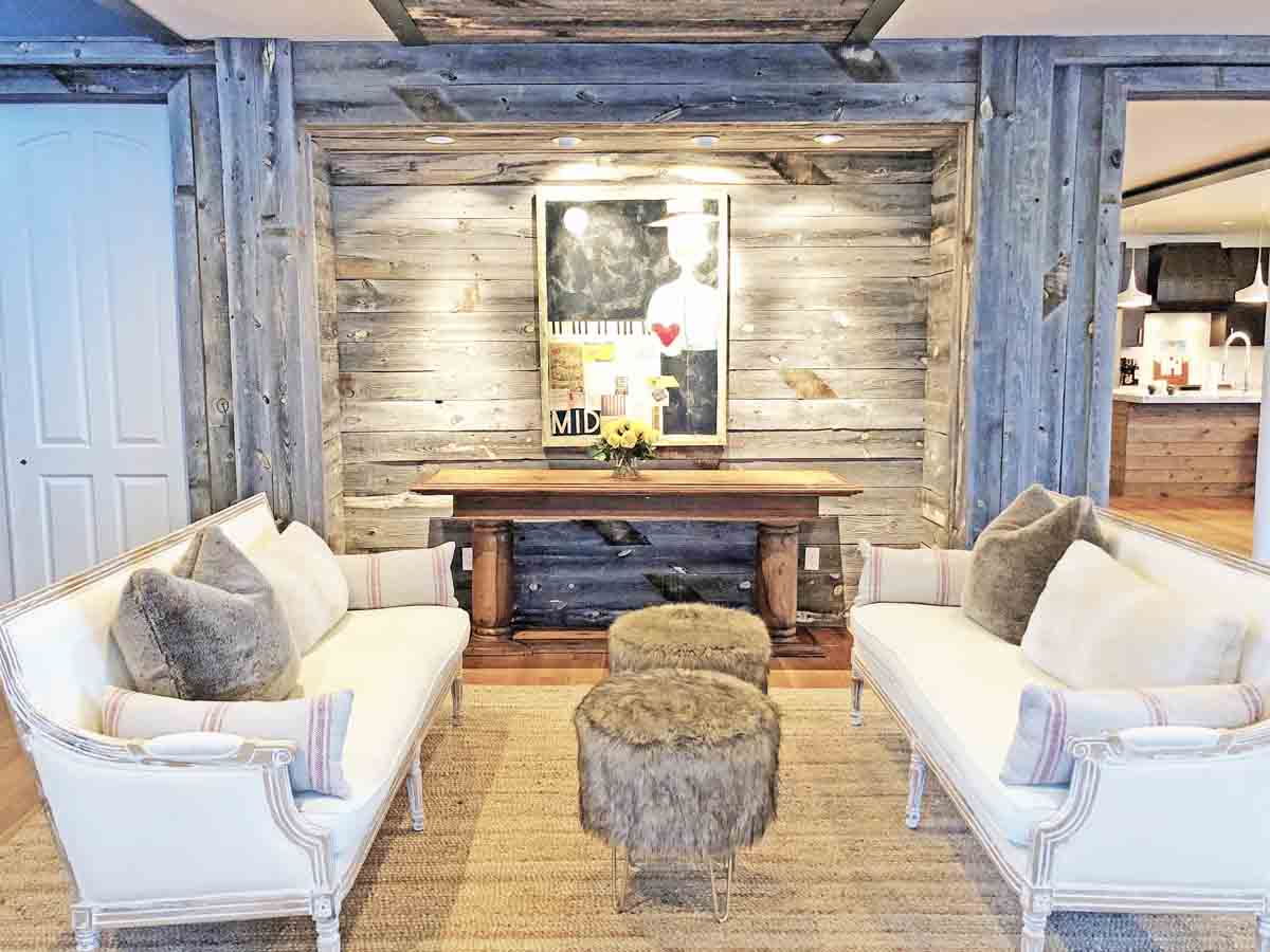 Grey reclaimed wood accent wall and posts in a chic modern ski chalet.