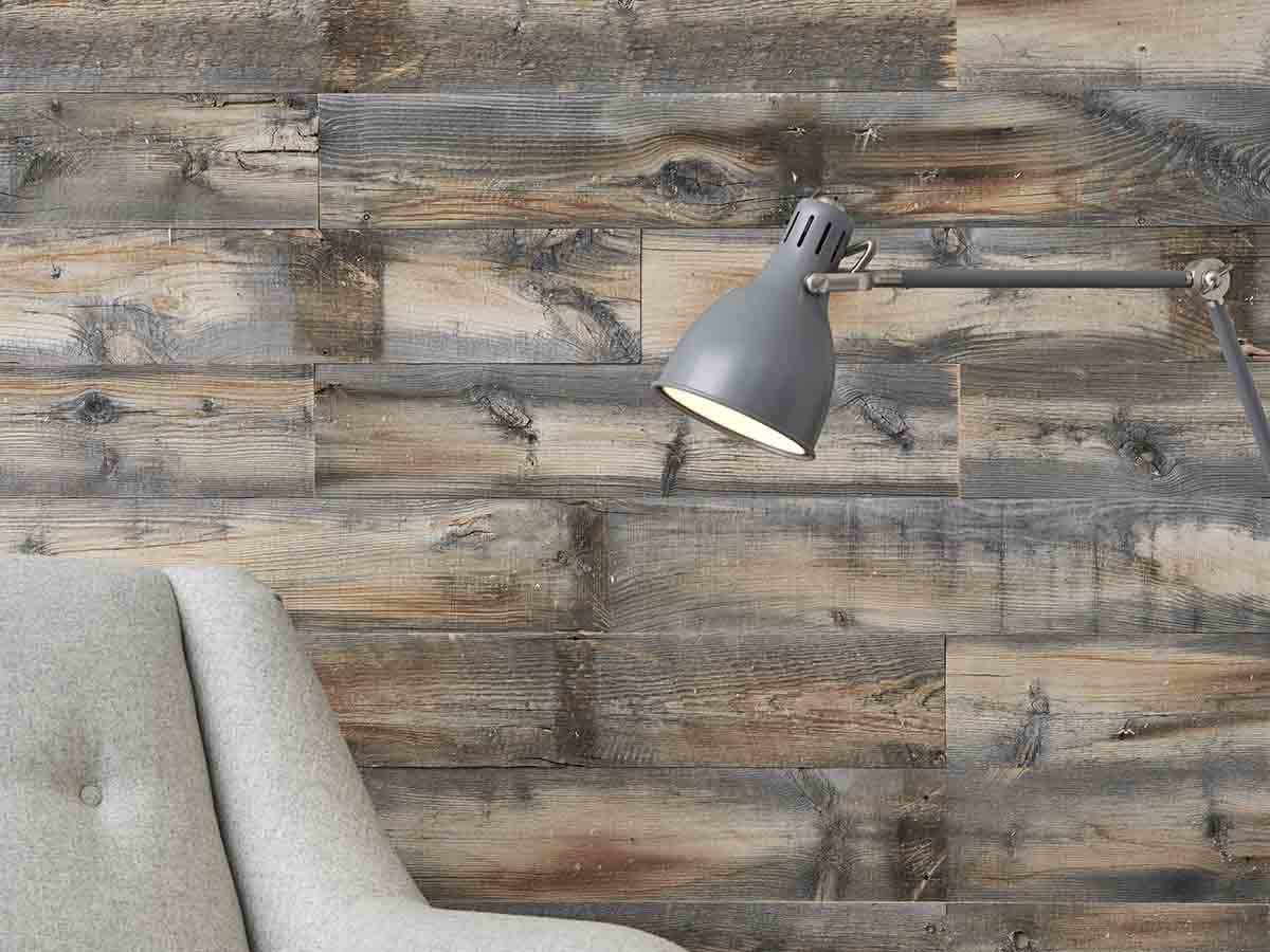 Reclaimed wood accent wall in a study with an upholstered chair and lamp.