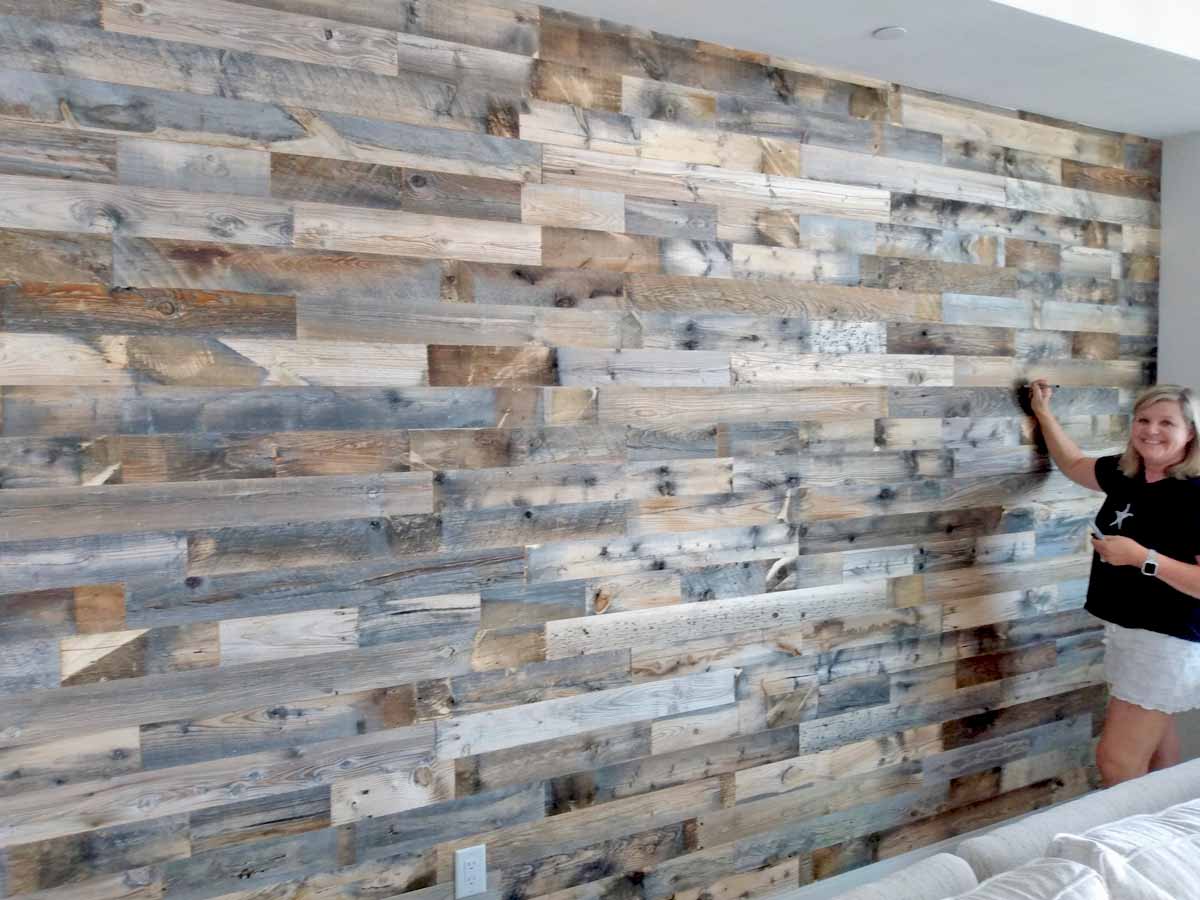 DIY accent wall using grey and brown reclaimed wood planks.