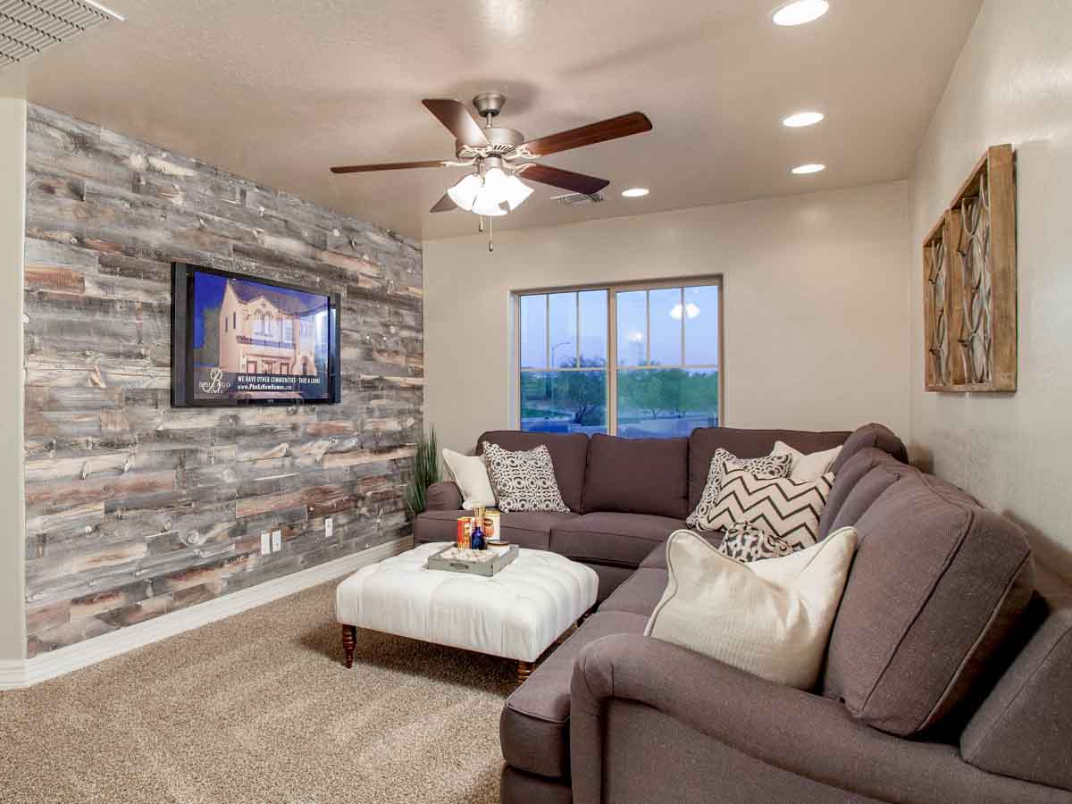 Light reclaimed wood paneling installed horizontally on an accent wall.