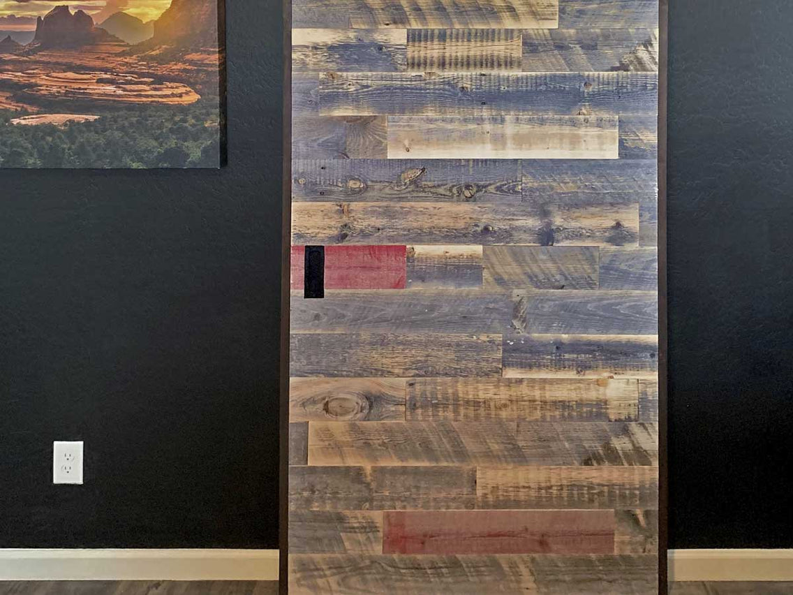 Reclaimed wood barn door with red accent planks.