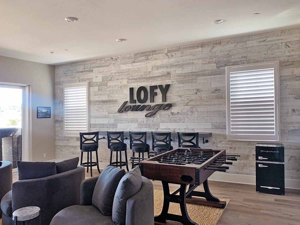 Sundance White reclaimed wood paneling on a wall in a game room