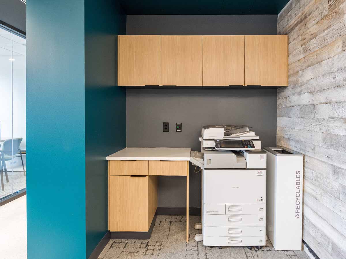White wash paint on a reclaimed wood wallin a modern office space with turquoise accents.