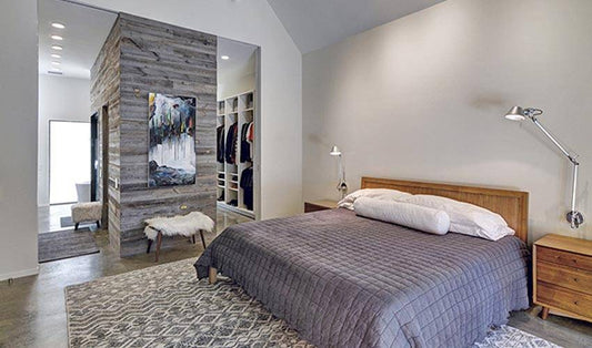 Minimalist bedroom with a reclaimed wood accent wall.