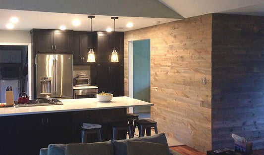 A brown reclaimed wood wall in a modern style kitchen.