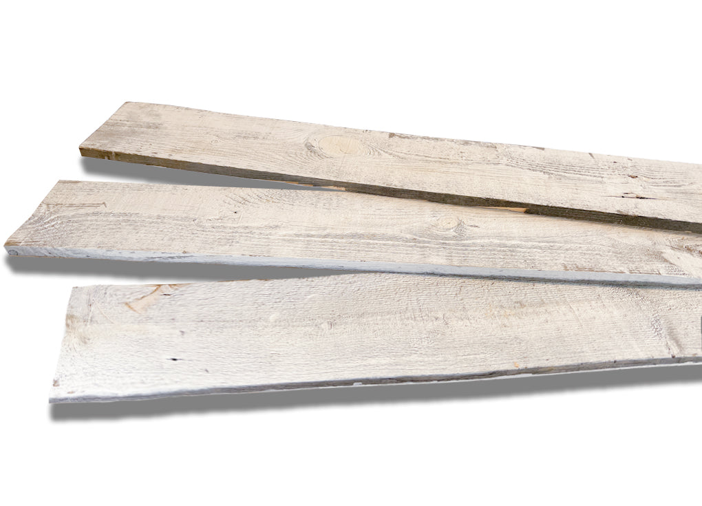 Make custom trim for your construction project using these whitewashed reclaimed wood boards prepped for going through a table saw.