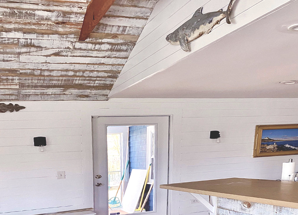 Distressed white reclaiimed wood ceiling in a coastal styled room