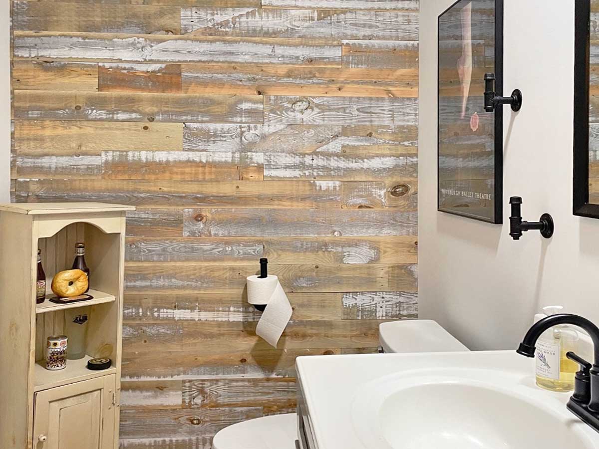 Distressed whitewashed wood paneling in a residential insdustrial style bathroom