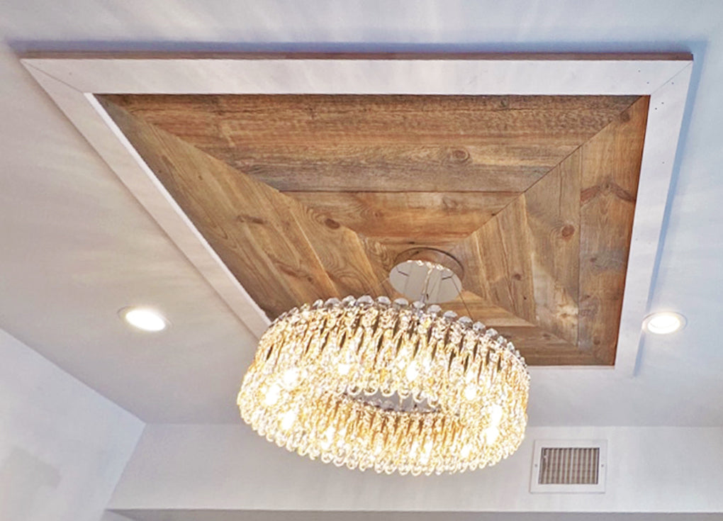 Cheyenne reclaimed wood installed on a ceiling as a base for a chandelier