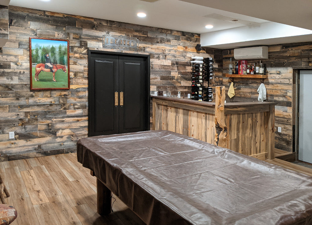 renovated basement with reclaimed wood walls, a corner bar, and a pool table