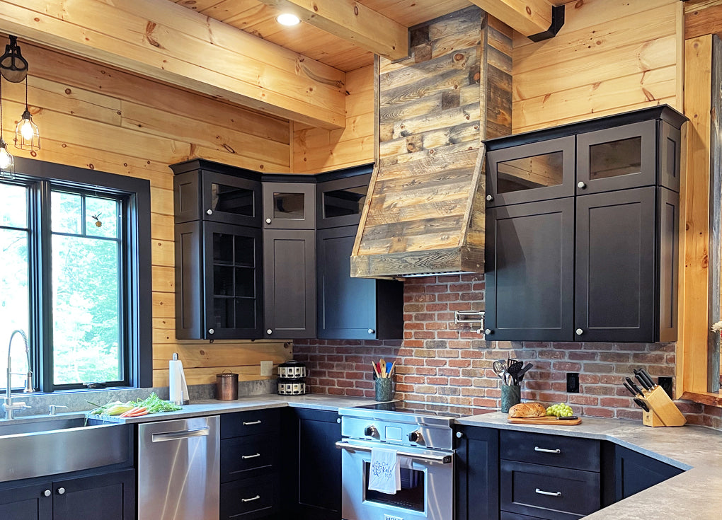 Centennial Woods' reclaimed wood planks in the Cody finish used to clad an oven hood in a farmhouse style kitchen