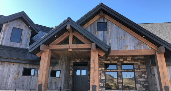 Reclaimed wood siding installed vertically using 1x6 nominal from Centennial Woods.
