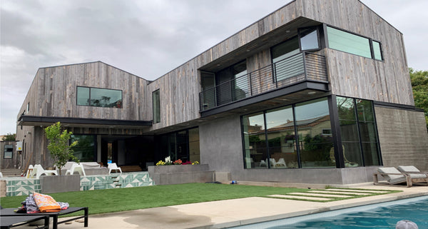 Poolside at a modern home featuring reclaimed wood siding by Centennial Woods