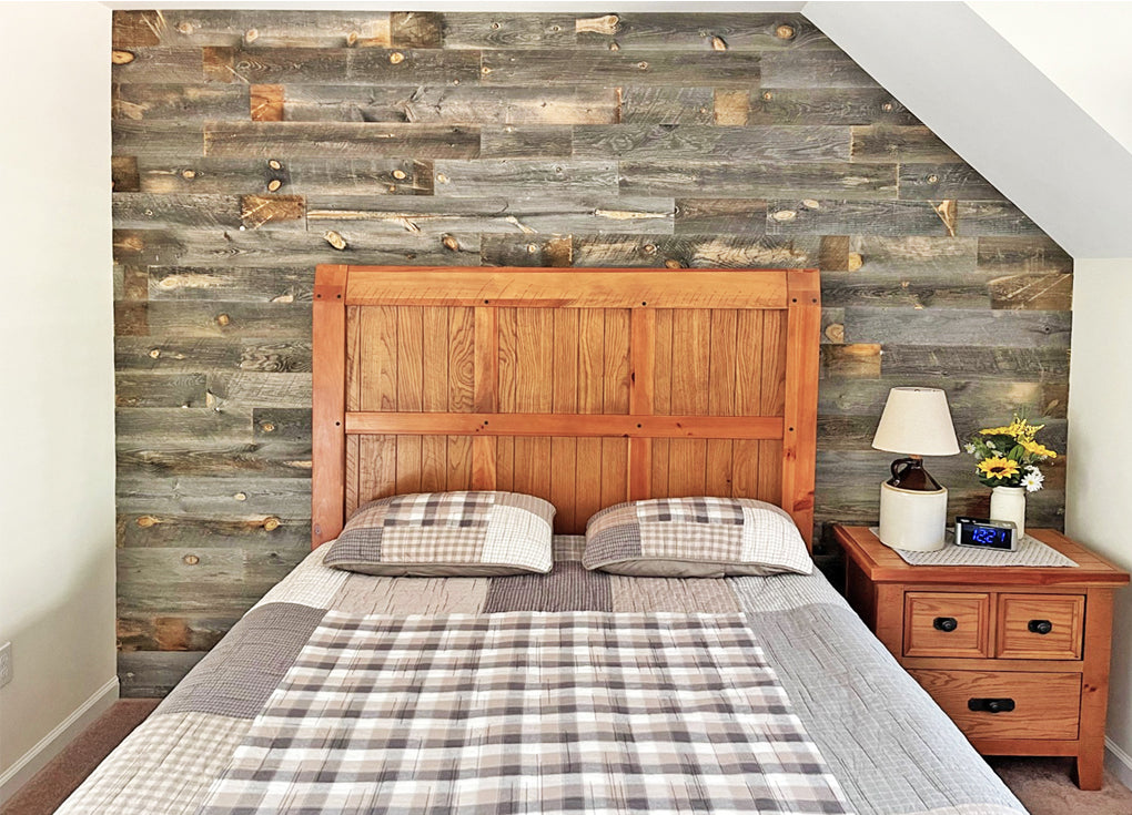 reclaimed wood wall in gray tones in a traditional style bedroom with a quilted bed spread