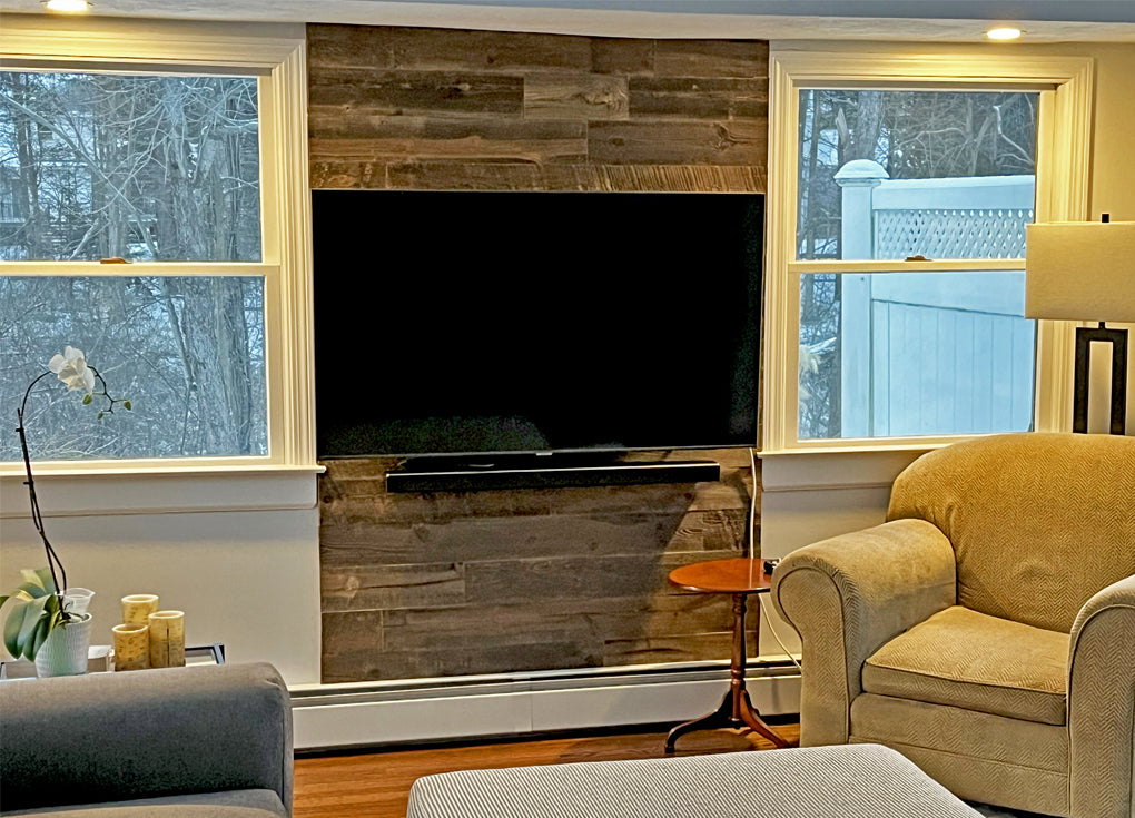 Dark brown reclaimed wood wall in a tv room with contemporary furnishings.