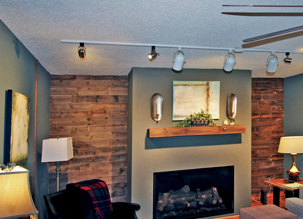 Saratoga reclaimed wood planks from Centennial Woods used as twin accent walls neighboring a fireplace in a living room.