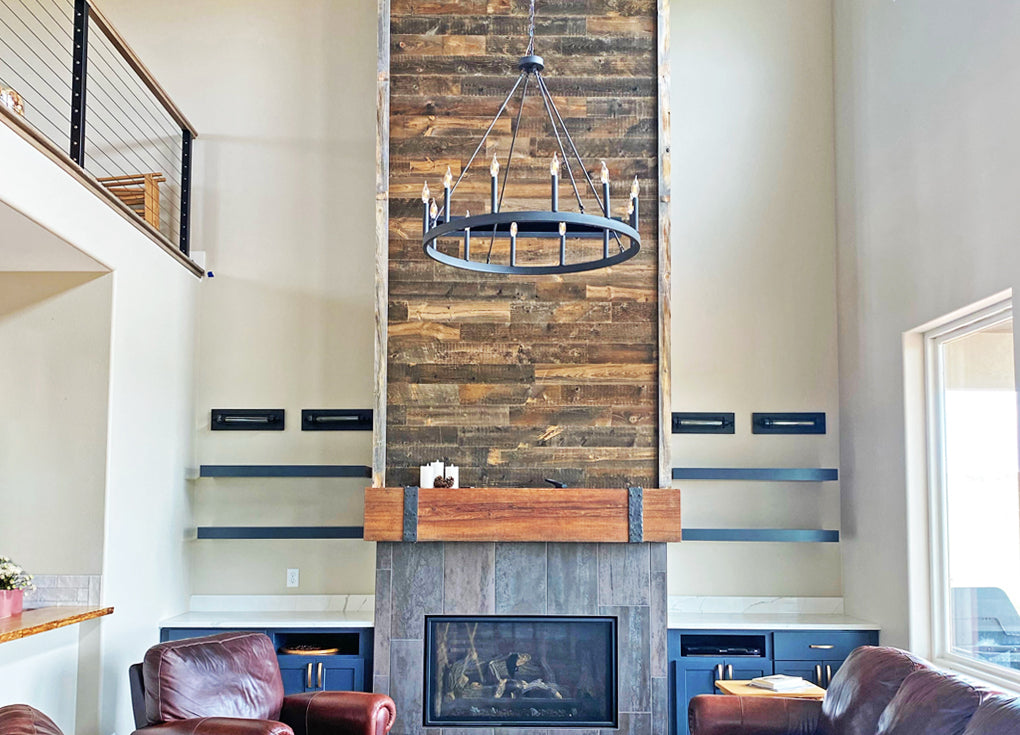 Modern rustic fireplace surround clad in deep brown reclaimed wood planks.