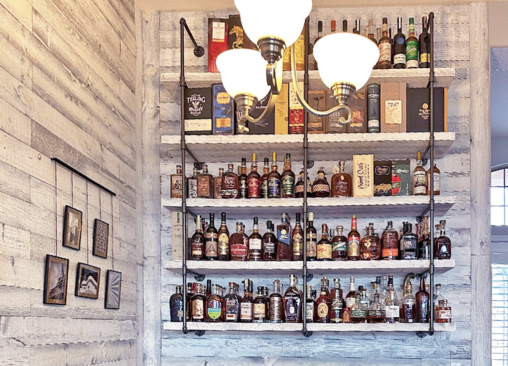 Sundance White reclaimed wood wall from Centennial Woods cladding a wall in a home bar