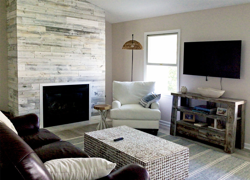 White reclaimed wood fireplace surround in a coastal styled room