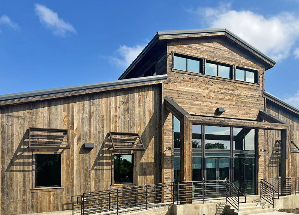 Brown reclaimed wood siding on a commercial building used as a rustic style wedding venue.