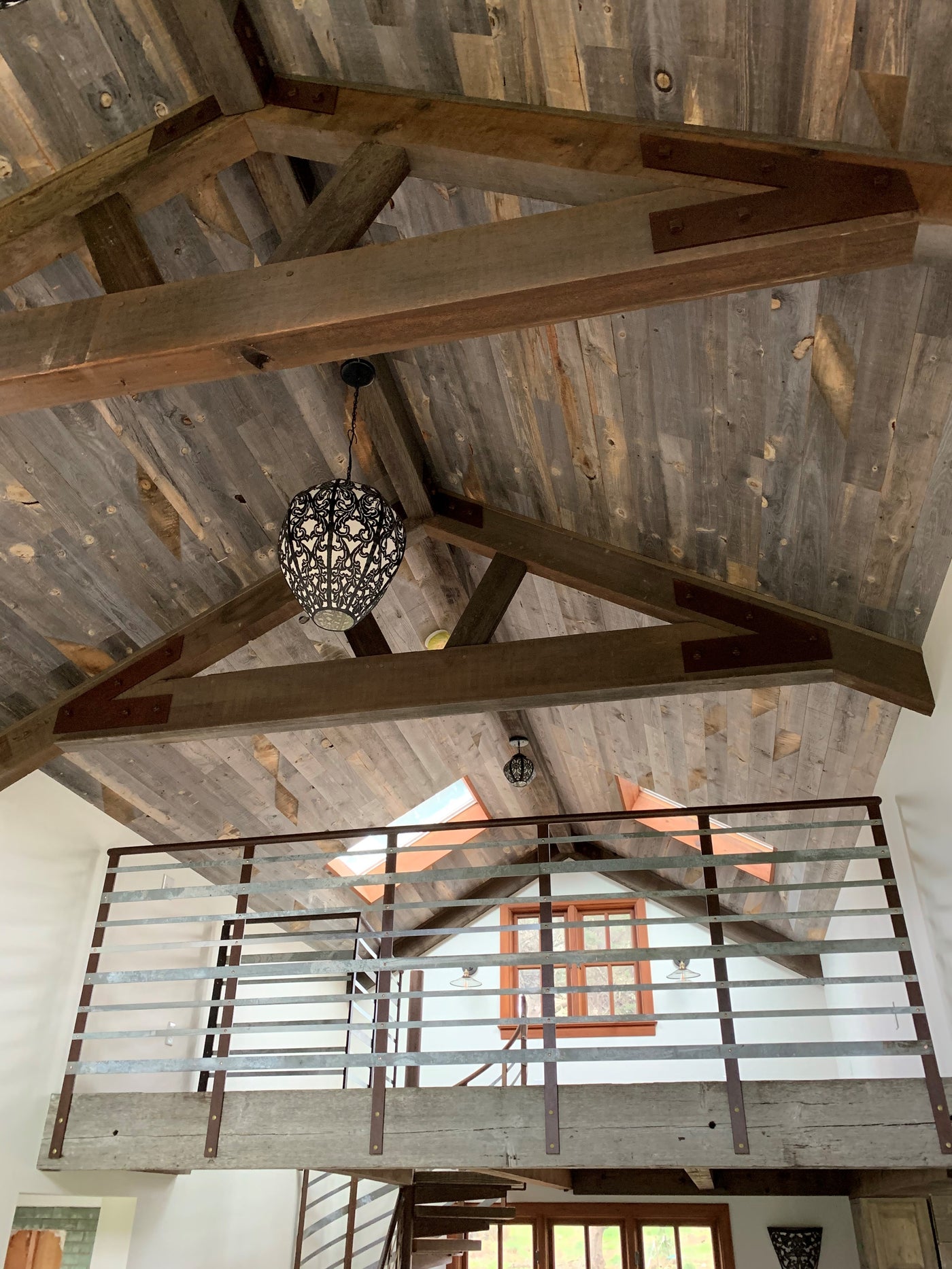 Classic reclaimed wood boards used to clad a gabled ceiling.
